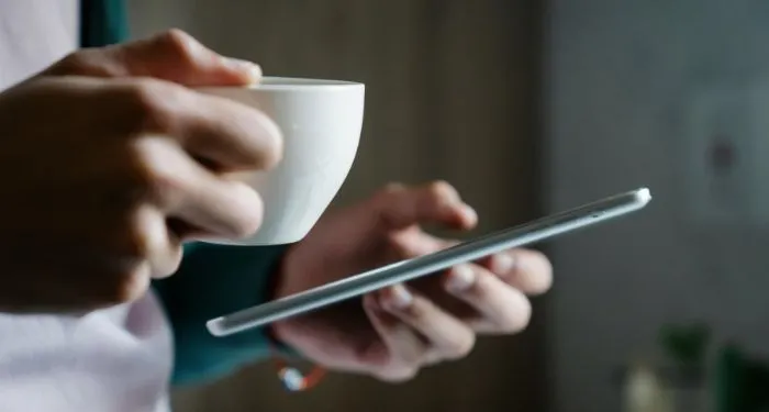 lighter-skinned-hands-holding-a-mug-and-tablet.jpg.webp.webp
